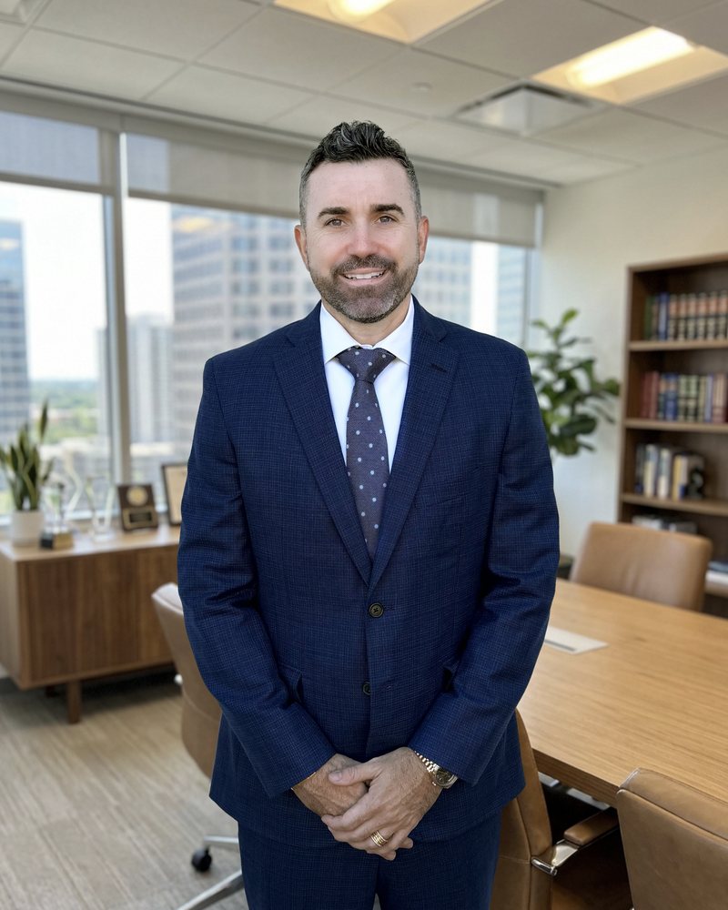 Portrait of Matthew Nicoletti in a navy suit in an office